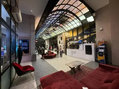 a lobby with red furniture and a large glass ceiling at Scarletz Suites KLCC by TaheeenS in Kuala Lumpur