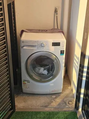 a washing machine with a towel on top of it at Cozy Fall Suite at EST Bangsar With Garden Scenery in Kuala Lumpur