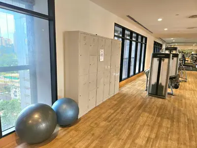 a gym with exercise balls and lockers in a room at Cozy Fall Suite at EST Bangsar With Garden Scenery in Kuala Lumpur