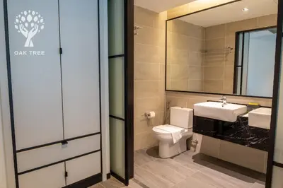 a bathroom with a toilet and a sink and a mirror at Red M101 Dang Wangi By Oak Tree in Kuala Lumpur