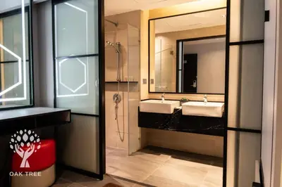 a bathroom with two sinks and a shower at Red M101 Dang Wangi By Oak Tree in Kuala Lumpur
