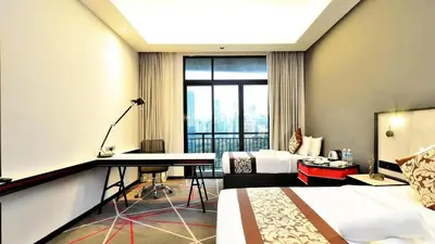 a hotel room with a desk and a bed at Red M101 Dang Wangi By Oak Tree in Kuala Lumpur