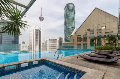 a swimming pool with a view of the city at COZY SUPER KING BED STUDIO walking to PETRONAS KLCC by Zen Glo in Kuala Lumpur