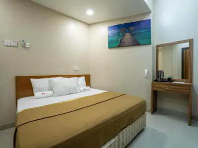 a hotel room with a bed and a mirror at AGE Hotel in Kuala Lumpur