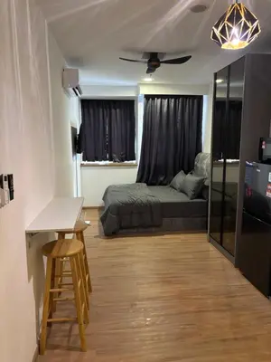 a bedroom with a bed and a desk and a table at Riveria City in Kuala Lumpur