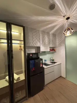 a kitchen with a black refrigerator and a sink at Riveria City in Kuala Lumpur