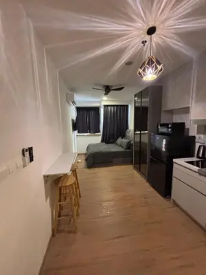 a kitchen and living room with a couch and a table at Riveria City in Kuala Lumpur
