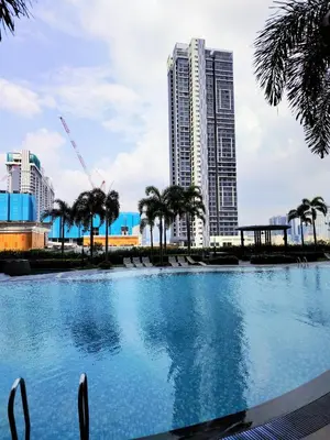 a large swimming pool in front of a tall building at Trion Residence Kuala Lumpur by Azure in Kuala Lumpur