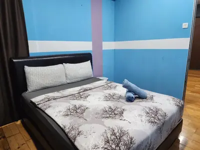 a bed with a teddy bear sitting on top of it at Regalia residence KLCC By Glory Homes in Kuala Lumpur