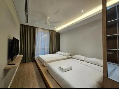 a hotel room with two beds and a television at Binjai 8 KLCC in Kuala Lumpur