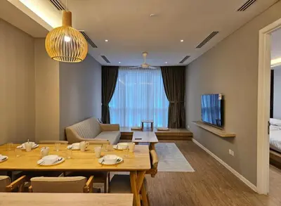 a dining room with a table and a tv at Binjai 8 KLCC in Kuala Lumpur