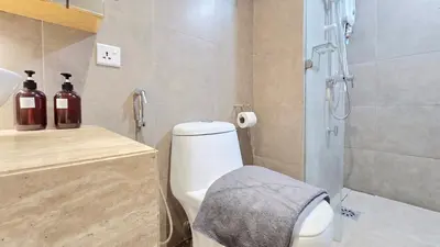 a bathroom with a shower and a toilet and a sink at Skyview Bukit Bintang Fairlane Residence #24 in Kuala Lumpur