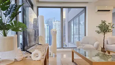 a living room with a view of a city at Skyview Bukit Bintang Fairlane Residence #24 in Kuala Lumpur