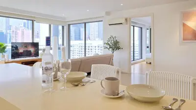 a dining room and living room with a table and chairs at Skyview Bukit Bintang Fairlane Residence #24 in Kuala Lumpur