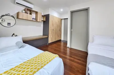 a hotel room with two beds and a mirror at Bukit Bintang Fairlane Residence #81 Pavilion Kuala Lumpur in Kuala Lumpur