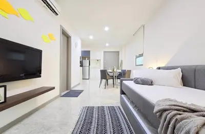 a bedroom with a bed and a tv and a table at Bukit Bintang Fairlane Residence #81 Pavilion Kuala Lumpur in Kuala Lumpur