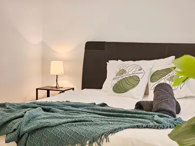 a bed with green and white pillows on it at Bukit Bintang Fairlane Residence #199 KL TRX Pavilion in Kuala Lumpur