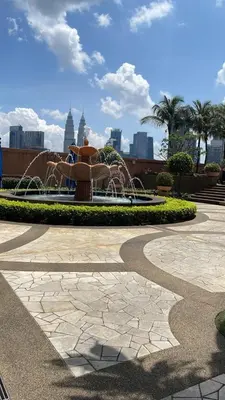 a fire hydrant in a park with a fountain at KL Marigold Apartment At Times Square in Kuala Lumpur