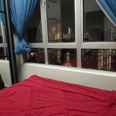 a bedroom with a window with a view of a city at 2 Rooms Apartment at Kuala Lumpur in Kuala Lumpur