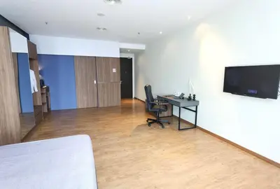 an office with a desk and a television on a wall at The Adina - Bangsar Trade Centre in Kuala Lumpur