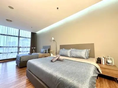 a hotel room with two beds and a large window at The Teak - Bangsar Trade Centre in Kuala Lumpur
