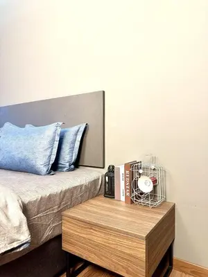 a bedroom with a bed with a wooden coffee table at The Teak - Bangsar Trade Centre in Kuala Lumpur