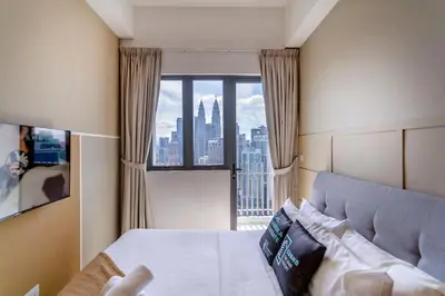 a bedroom with a bed and a large window at The Colony & Luxe Kuala Lumpur with Skypool by Cobnb in Kuala Lumpur