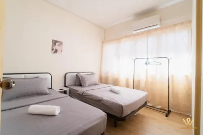 a bedroom with two beds and a window at Gather & Stay 5BR Cozy Home near Setapak & Wangsa Maju in Kuala Lumpur