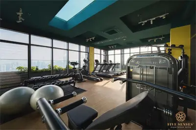 a gym with a row of treadmills and machines at Riveria Signature Suites, KL Sentral in Kuala Lumpur