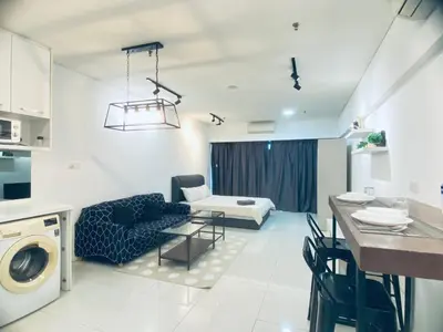 a kitchen and living room with a couch and a table at Summer Suites KLCC by EASY STAY in Kuala Lumpur