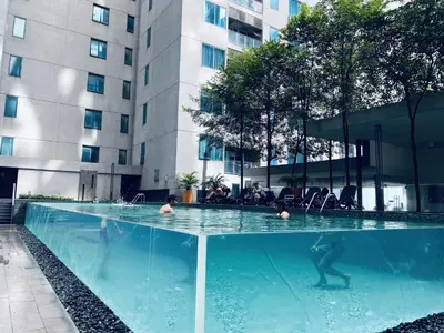 a group of people in a swimming pool in a building at Summer Suites KLCC by EASY STAY in Kuala Lumpur