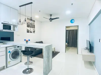 a kitchen with a washing machine in a room at Summer Suites KLCC by EASY STAY in Kuala Lumpur