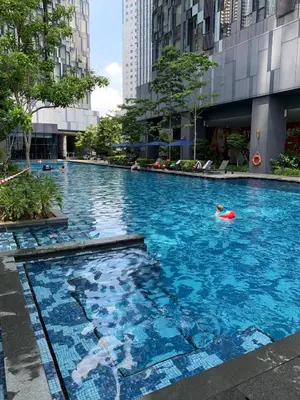 a person swimming in a large swimming pool in a city at Star Residence 1R1B KLCC in Kuala Lumpur