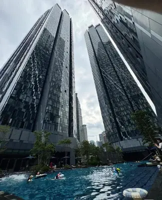 a pool in a city with two tall buildings at Star Residence 1R1B KLCC in Kuala Lumpur