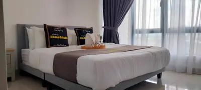 a bedroom with a large bed with pillows on it at LSH33 Residence Sentul KL by HomeBrickz in Kuala Lumpur