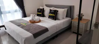 a bedroom with a large white bed with pillows at LSH33 Residence Sentul KL by HomeBrickz in Kuala Lumpur