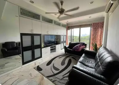 a living room with a black leather couch and a television at Condo in kuala lumpur in Kuala Lumpur