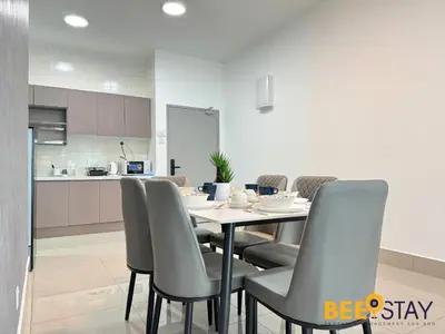 a dining room with a table and chairs and a kitchen at Salak Selatan Pool View with Wifi & Netflix 4PAX in Kuala Lumpur