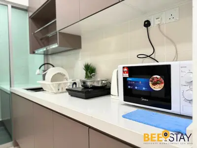 a microwave oven on a counter in a kitchen at Salak Selatan Pool View with Wifi & Netflix 4PAX in Kuala Lumpur