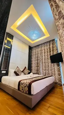a bedroom with a large bed with a ceiling at Dorsett Residence Service Suites at Kuala Lumpur in Kuala Lumpur