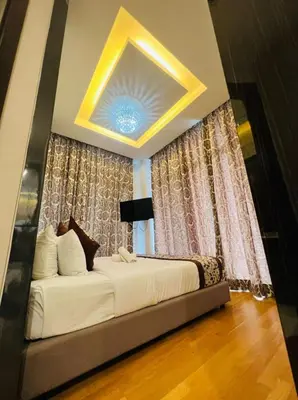 a bedroom with a large bed in front of curtains at Dorsett Residence Service Suites at Kuala Lumpur in Kuala Lumpur