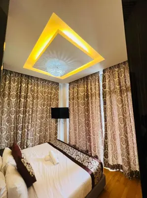 a bedroom with a large bed and a yellow ceiling at Dorsett Residence Service Suites at Kuala Lumpur in Kuala Lumpur