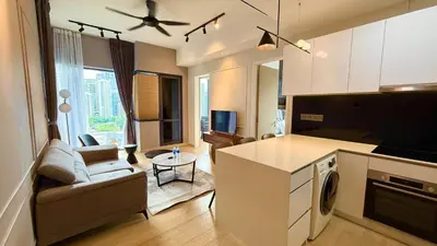 a kitchen and living room with a couch and a table at Star Suites KLCC by flixses in Kuala Lumpur