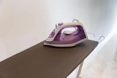 a purple and white iron sitting on a table at The Signature Residence at Sri Hartamas - 2 pax in Kuala Lumpur