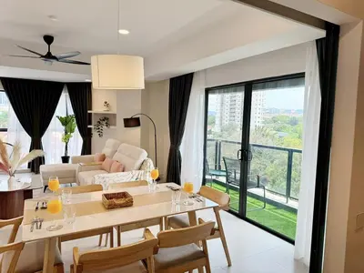 a dining room and living room with a table and chairs at The Atrium at Jalan Ampang by OKBnB - Spacious Modern 3Bedroom Family Suite 3 mins to KLCC in Kuala Lumpur