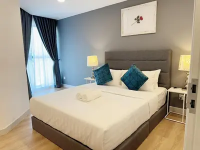 a bedroom with a large bed with blue walls at The Atrium at Jalan Ampang by OKBnB - Spacious Modern 3Bedroom Family Suite 3 mins to KLCC in Kuala Lumpur