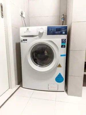a washing machine sitting in a room with a tile floor at The Atrium Ampang by OKBnB - Family Suite 3-Minute Access to the Heart of KL in Kuala Lumpur