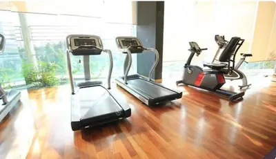 three exercise bikes in a gym with a wooden floor at 0111 Sweet Home-Casa Residency 2R 2B City View in Kuala Lumpur