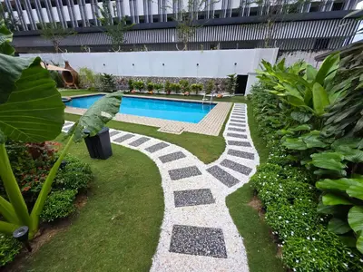 a garden with a swimming pool in a building at Bungalow Perkasa in Kuala Lumpur