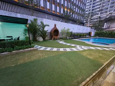 a garden with a swimming pool in a building at Bungalow Perkasa in Kuala Lumpur